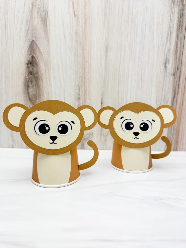 two side by side examples of finished monkey paper cup craft