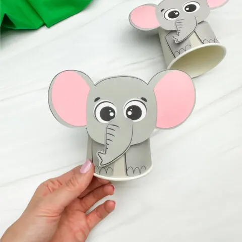 hand holding finished elephant paper cup craft