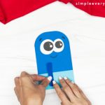 hands gluing popsicle parts onto main body