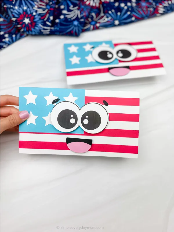 hand holding flag card craft with another example in background