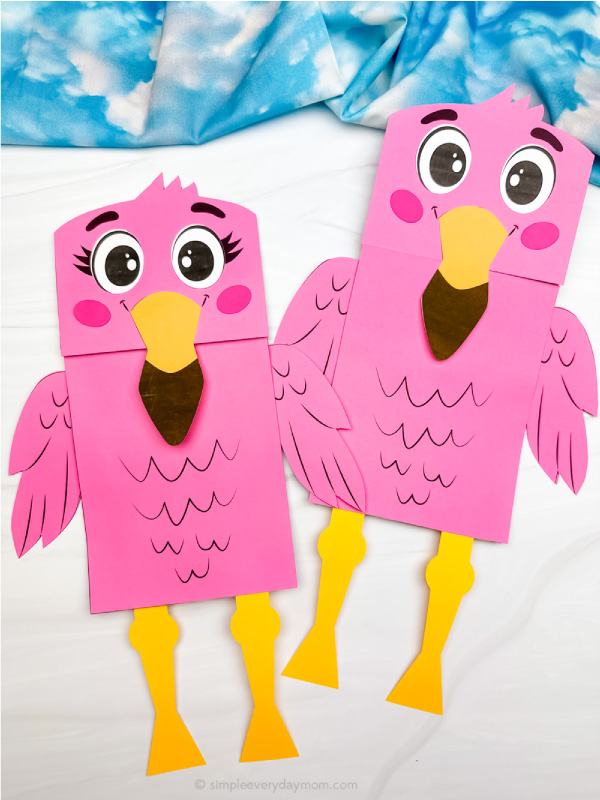 two finished flamingo paper bag puppet crafts