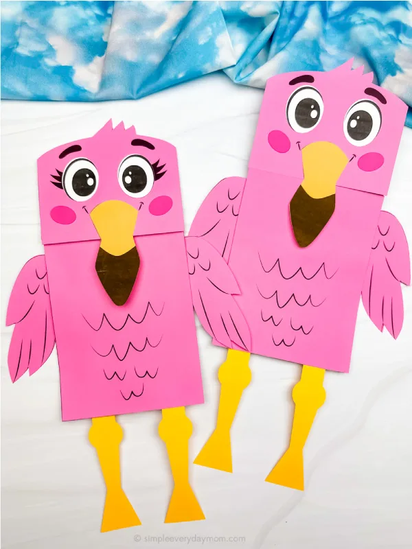 two finished flamingo paper bag puppet crafts