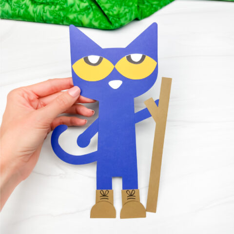 hand holing Pete the cat goes camping craft