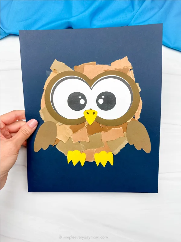 hand holding example of finished torn paper owl craft