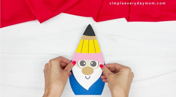 hands gluing head to back to school gnome craft