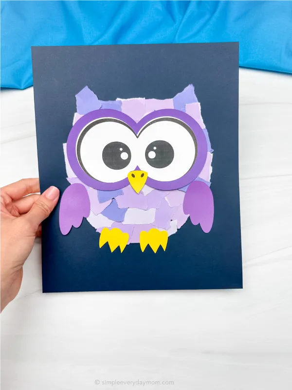 hand holding torn paper owl craft