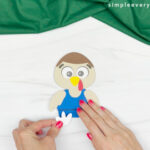hands gluing feet onto turkey
