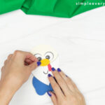 hands gluing nose to turkey face