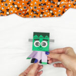 hands gluing arms to body of Frankenstein