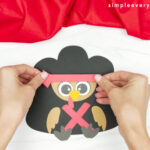 hands gluing headband to turkey head
