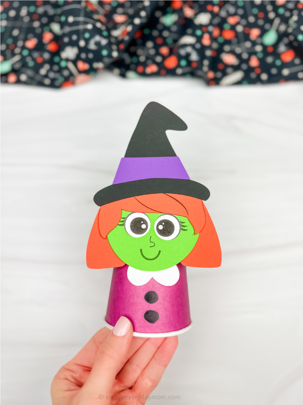 hand holding finished example of witch paper cup craft