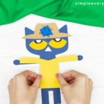 hands gluing shirt to Pete the cat scarecrow craft