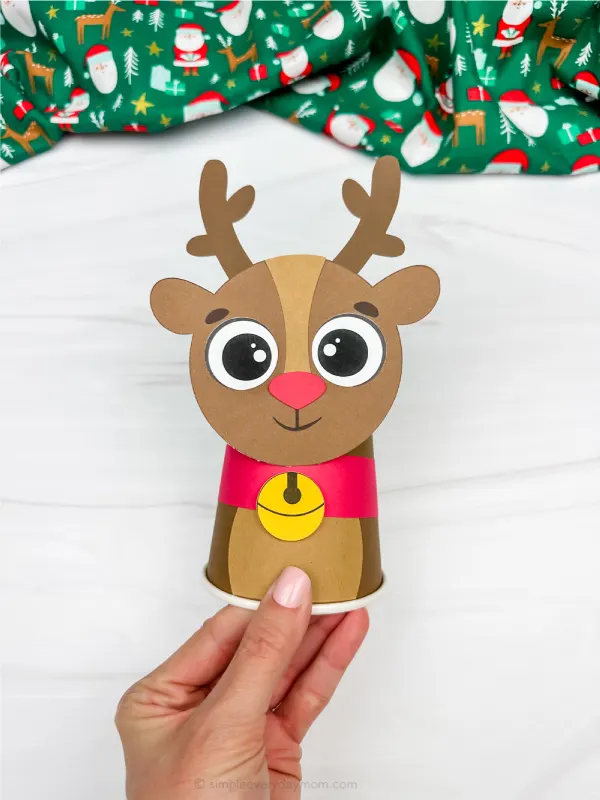 hand holding single example of reindeer paper cup craft