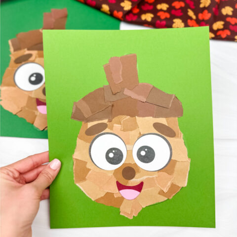 hand holding finished torn paper acorn craft
