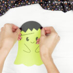 hands gluing hair on top of ghost