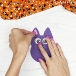 hands gluing ears to bat card craft