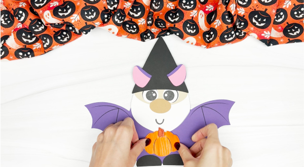 hands gluing pumpkin template to bat gnome craft