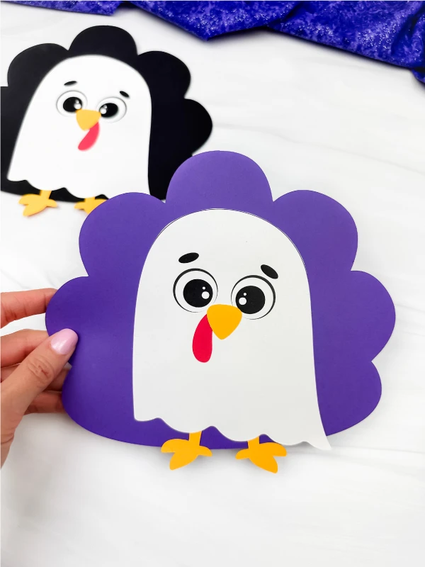 holding the violet version of ghost turkey disguise craft