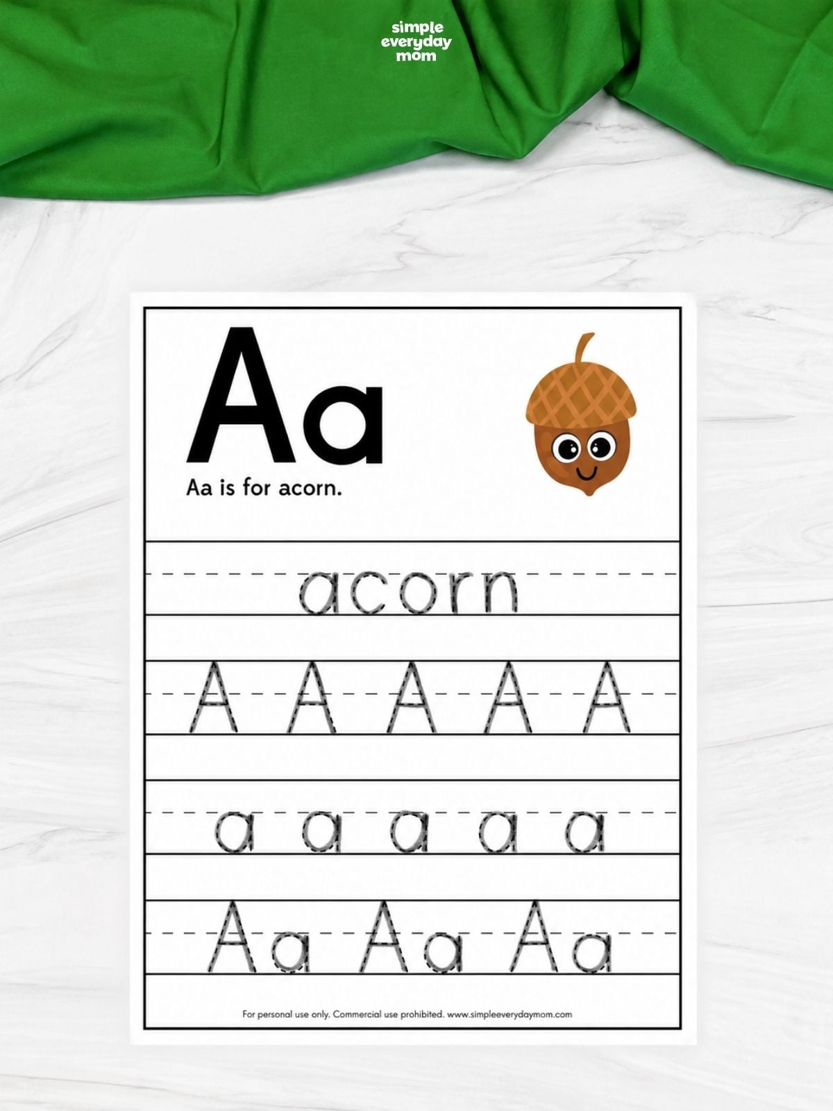 Letter A handwriting worksheet reading “Aa is for acorn,” with a cartoon acorn and tracing practice for the word “acorn,” uppercase A, lowercase a, and Aa pairs.