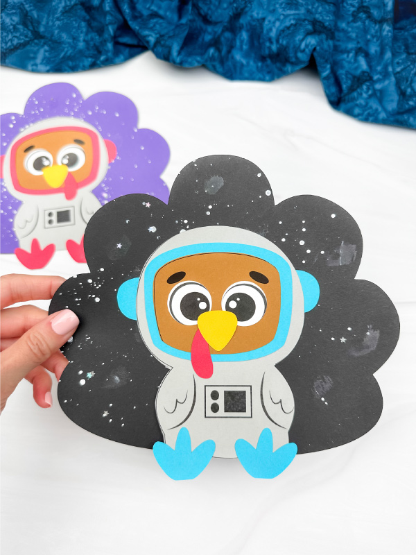holding the astronaut disguise a turkey craft
