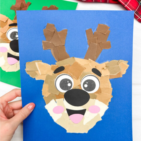 holding the blue background of torn paper reindeer craft
