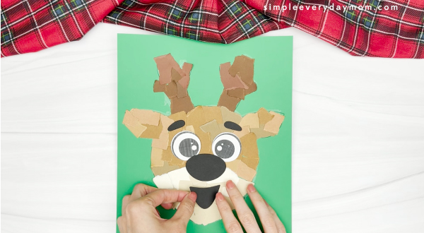 hand gluing the mouth of the torn paper reindeer craft