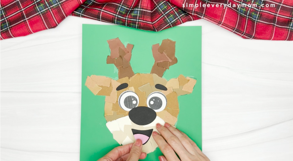 hand gluing the tongue of the torn paper reindeer craft