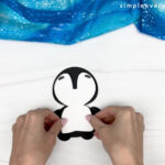 hand gluing the penguin belly