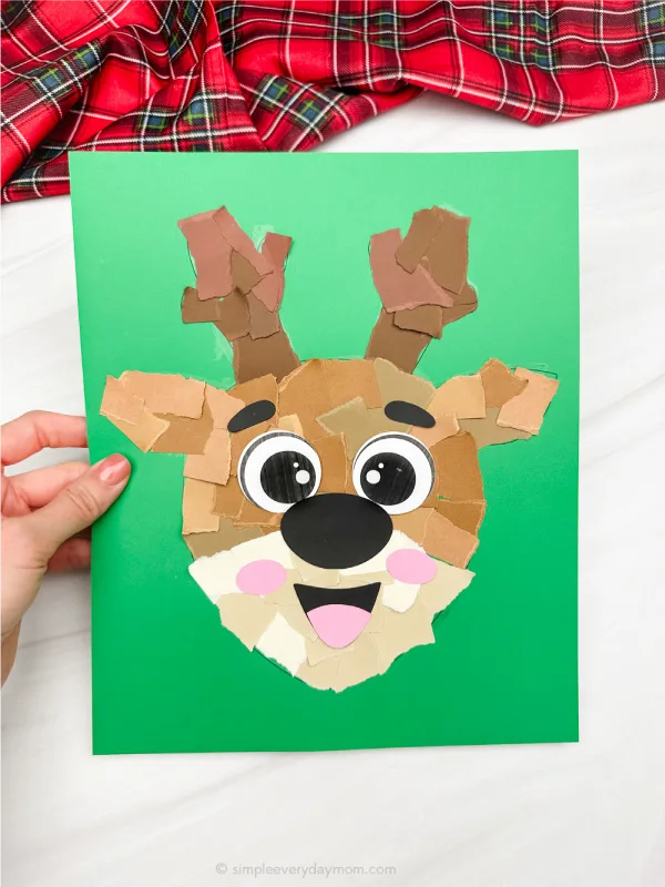 holding the reindeer torn paper craft 