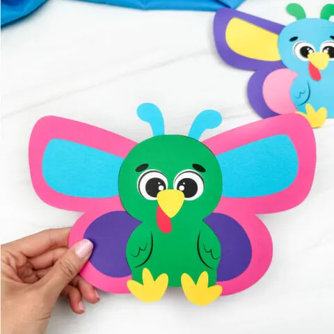 holding the image of butterfly disguise a turkey craft second version