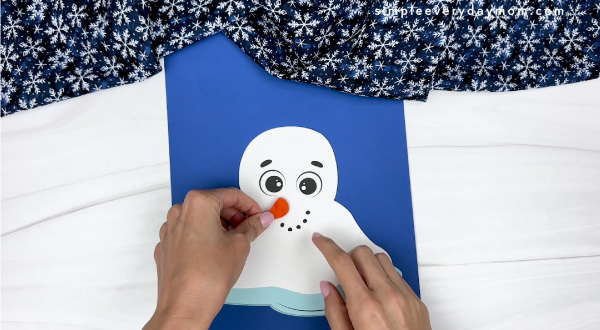 hand gluing the nose of melted snowman craft