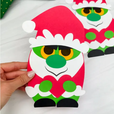 holding the grinch gnome craft with background on right side