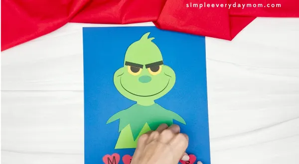 completing the heart letter to spell out the name of the grinch name craft