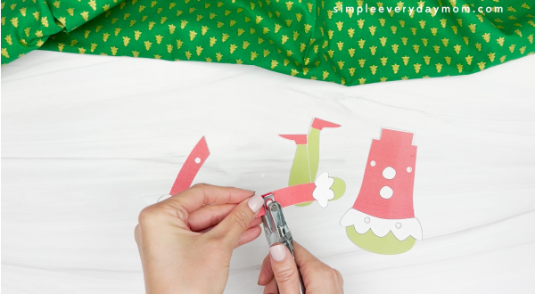 punching the arm piece of the grinch photo craft