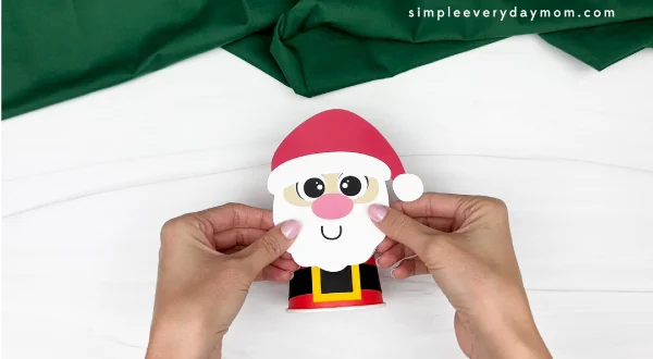 hand gluing the santa head to the paper cup