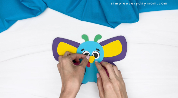 handgluing the beak of the butterfly turkey disguise craft