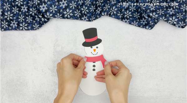 hand gluing the scarf of how to catch a snowman craft
