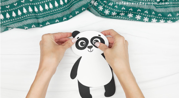 hand gluing ear to panda christmas craft