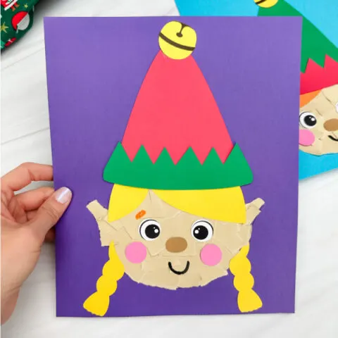 holding the torn elf paper craft with background