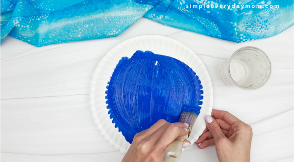 painting the paper plate of moving penguin paper plate craft