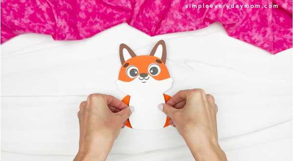 hand gluing the arms of the valentine fox craft