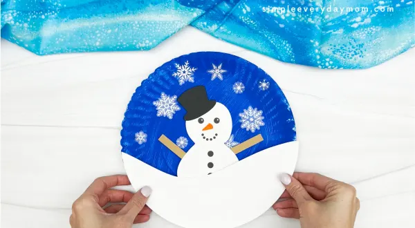 hand gluing the snow of snowman craft