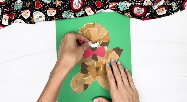 hand gluing the gingerbread mouth