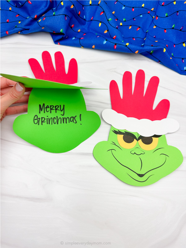 dual image of grinch handprint craft opening the other one
