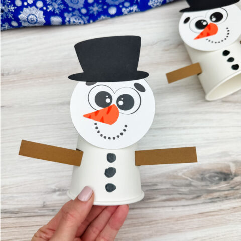holding the snowman paper cup craft