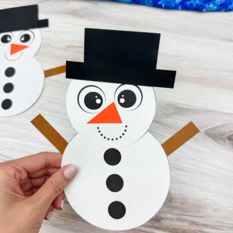 holding the snowman shape craft