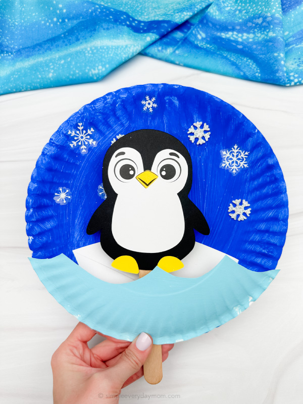 holding the moving penguin paper plate craft