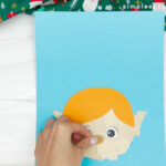 hand gluing the nose of torn paper elf craft