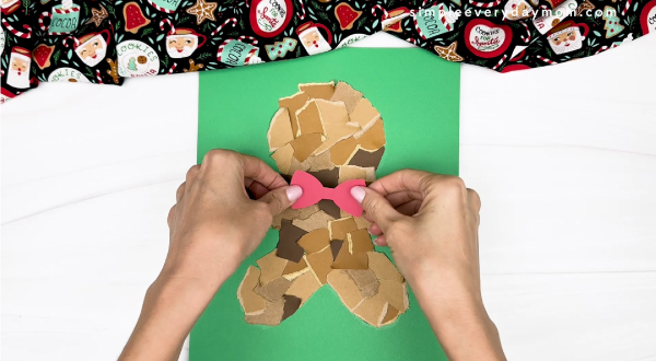 hand gluing the gingerbread body and ribbon