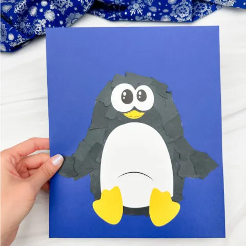 holding the torn paper penguin craft